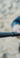 White police officer with NEX LOCKING BATON outdoor with grey brick wall blurred out